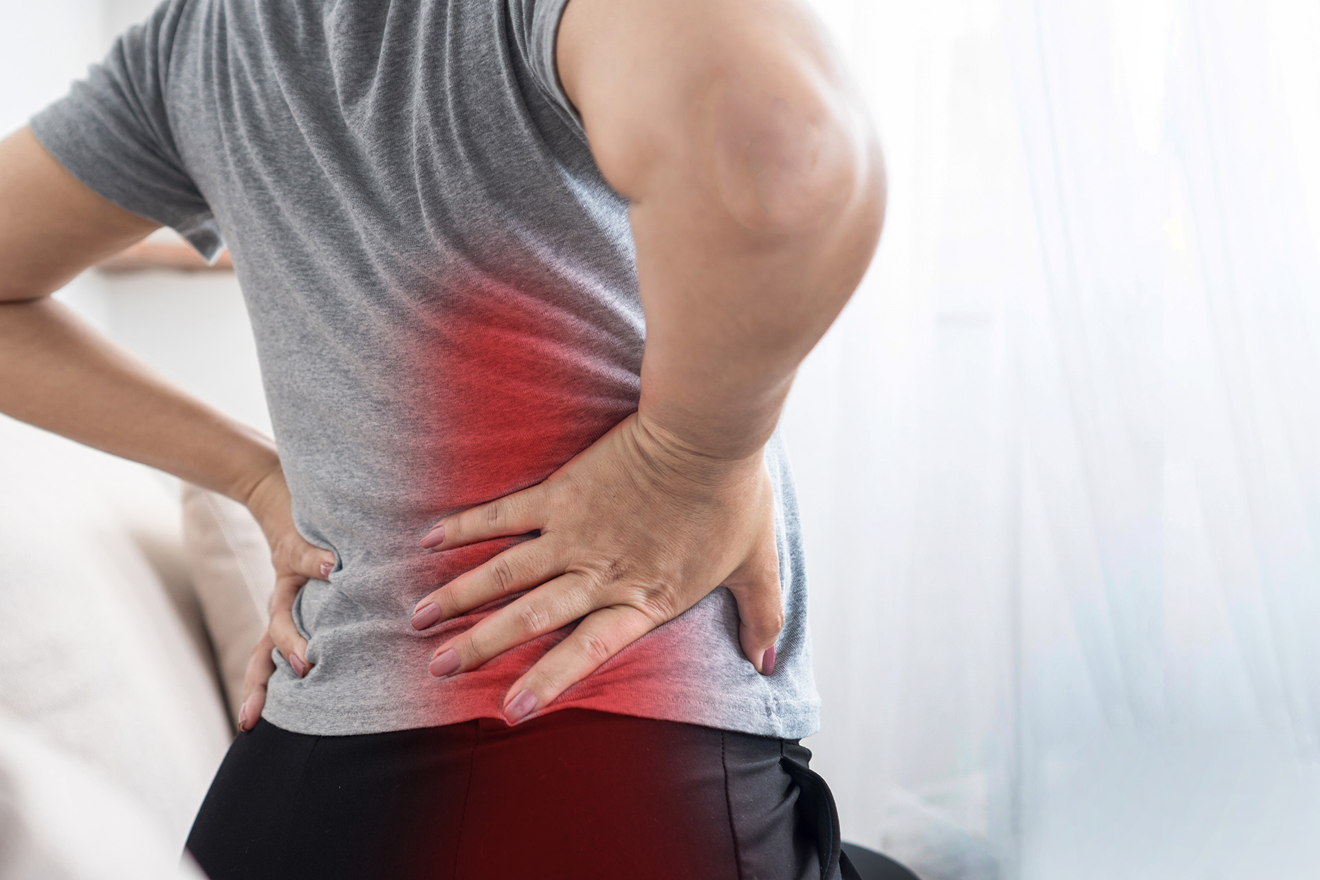 Person holding back in pain